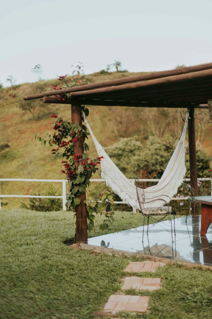 pexels-photo-25614393-25614393 Relaxing hammock setup in a garden with scenic landscape view, perfect for outdoor tranquility.